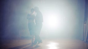 Couple dancing rhumba in the fog
