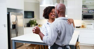 Couple dancing together in kitchen 4k