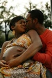 Couple Expecting Baby Kissing Stock Photo Couple Expecting Baby Kissing Stock Photo