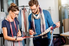 Couple of fashion designers working at the studio royalty free stock photo Couple of fashion designers working at the studio royalty free stock photo