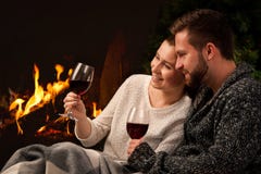 Couple with glass of wine at fireplace Stock Photo Couple with glass of wine at fireplace Stock Photo