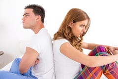 Couple having an argument while they sitting on bed stock image Couple having an argument while they sitting on bed stock image