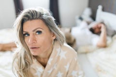 Couple having crisis in bed. Woman sitting on bed`s edge royalty free stock photos Couple having crisis in bed. Woman sitting on bed`s edge royalty free stock photos