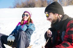 Couple having fun on the sleds royalty free stock images Couple having fun on the sleds royalty free stock images