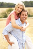 Couple Having Piggyback In Summer Harvested Field Royalty Free Stock Image Couple Having Piggyback In Summer Harvested Field Royalty Free Stock Image