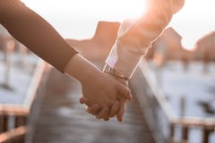 Couple holding they`re hands in the sunshine stock photo Couple holding they`re hands in the sunshine stock photo