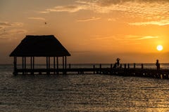 Couple In Love At A Wooden Pier Palapa Enjoying Sunset At Holbox Island Near Cancun, Traveling Riviera Maya. Mexico Adventure. Royalty Free Stock Photography Couple In Love At A Wooden Pier Palapa Enjoying Sunset At Holbox Island Near Cancun, Traveling Riviera Maya. Mexico Adventure. Royalty Free Stock Photography