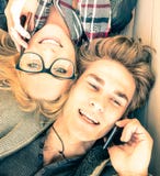 Couple in love having fun with smartphones at spring time royalty free stock image Couple in love having fun with smartphones at spring time royalty free stock image