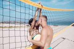 Couple in love play volleyball on sunny beach. Summer vacation and travel on holiday in Miami. Love and flirting of stock photos Couple in love play volleyball on sunny beach. Summer vacation and travel on holiday in Miami. Love and flirting of stock photos