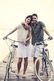 Couple in love pushing their bike together on a boardwalk stock images Couple in love pushing their bike together on a boardwalk stock images
