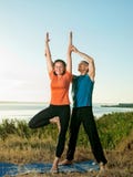 Couple making yoga exercises outdoors Royalty Free Stock Images Couple making yoga exercises outdoors Royalty Free Stock Images