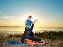 Couple making yoga exercises outdoors Royalty Free Stock Photo Couple making yoga exercises outdoors Royalty Free Stock Photo