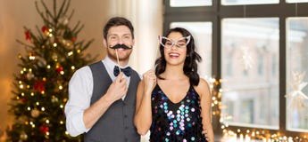 Couple with party props having fun on christmas stock images Couple with party props having fun on christmas stock images