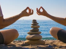 Couple practicing yoga on the beach. Zen. Calm and relax. stock image Couple practicing yoga on the beach. Zen. Calm and relax. stock image