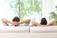 Couple relaxing on a couch at home royalty free stock photography Couple relaxing on a couch at home royalty free stock photography