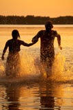 Couple running in lake Royalty Free Stock Photo Couple running in lake Royalty Free Stock Photo