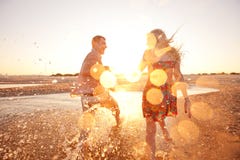 Couple Running On The Beach Royalty Free Stock Image