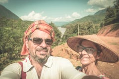 Couple selfie on mountain top at Nong Khiaw panoramic view over Nam Ou River valley Laos travel destination in South East Asia, stock images Couple selfie on mountain top at Nong Khiaw panoramic view over Nam Ou River valley Laos travel destination in South East Asia, stock images
