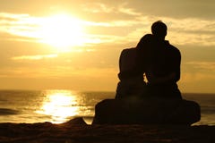 Couple Silhouette Watching Sunset On The Beach Stock Photography Couple Silhouette Watching Sunset On The Beach Stock Photography