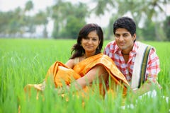 Couple Sitting In A Paddy Field Royalty Free Stock Photos