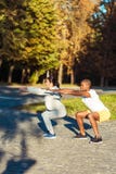 couple squatting in park stock images couple squatting in park stock images