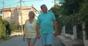Couple of tourists walking along the side street stock footage Couple of tourists walking along the side street stock footage