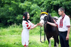Couple in Ukrainian costumes with a horse Royalty Free Stock Photography Couple in Ukrainian costumes with a horse Royalty Free Stock Photography