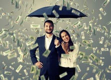 Couple under money rain