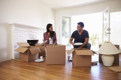 Couple Unpacking Boxes In New Home On Moving Day royalty free stock photo Couple Unpacking Boxes In New Home On Moving Day royalty free stock photo