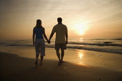 Couple Walking on Beach at Sunset