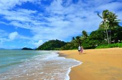 Couple walks on Trinity beach near Cairns Queensland Australia stock photography Couple walks on Trinity beach near Cairns Queensland Australia stock photography