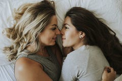 Couples lesbiens ensemble dans le lit photographie stock libre de droits Couples lesbiens ensemble dans le lit photographie stock libre de droits