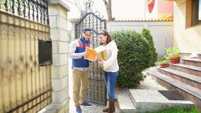 Courier Delivering a Package. To a happy woman Courier Delivering a Package. To a happy woman