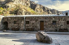 Geghard monastery of Armenia with holy stone and benches for pilgrims near the room for priests royalty free stock photos Geghard monastery of Armenia with holy stone and benches for pilgrims near the room for priests royalty free stock photos
