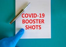 Covid-19 booster shots vaccine symbol. White note with words Covid-19 booster shots, beautiful blue background, doctor hand and