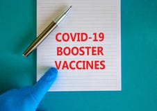 Covid-19 booster shots vaccines symbol. White note with words Covid-19 booster vaccines, beautiful blue background, doctor hand