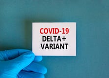 Covid-19 delta plus variant strain symbol. Hand in blue glove with white card. Concept words Covid-19 delta plus variant. Medical