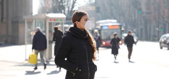 COVID-19 Pandemic Coronavirus Young woman in city street wearing face mask protective for spreading of Coronavirus Disease 2019.