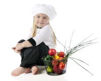 Cozinheiro chefe pequeno por seus vegetarianos Imagens de Stock Royalty Free Cozinheiro chefe pequeno por seus vegetarianos Imagens de Stock Royalty Free