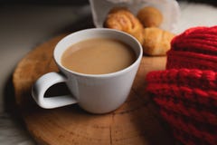 Cozy Autumn Evening: Coffee, Knitting And Croissants, Close-up Lie On A Table And A Wooden Tray Stock Photo