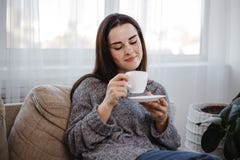 Cozy young woman drinking coffee in living room royalty free stock photos Cozy young woman drinking coffee in living room royalty free stock photos