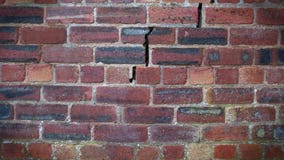 A Crack Forming In A Red Brick Wall