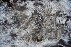 Cracked ice on shallow water with stones inside stock photo Cracked ice on shallow water with stones inside stock photo