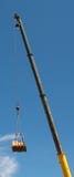A crane lifting a pallet with a heavy cable royalty free stock image A crane lifting a pallet with a heavy cable royalty free stock image