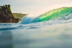 Crashing ocean wave. Breaking green barrel wave with sunset light. Crashing ocean wave. Breaking green barrel wave with sunset Stock Photos Crashing ocean wave. Breaking green barrel wave with sunset light. Crashing ocean wave. Breaking green barrel wave with sunset Stock Photos