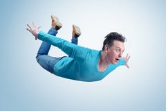 Crazy man in shirt and jeans is flying in the sky. Jumper concept stock photo Crazy man in shirt and jeans is flying in the sky. Jumper concept stock photo
