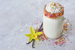Crazy vanilla milk shake with whipped cream and colored sprinkles in glass jar Royalty Free Stock Image Crazy vanilla milk shake with whipped cream and colored sprinkles in glass jar Royalty Free Stock Image