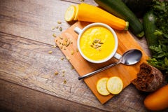 Cream soup of pumpkin served with roasted seeds and croutons on a wooden background. Food concept. stock image Cream soup of pumpkin served with roasted seeds and croutons on a wooden background. Food concept. stock image