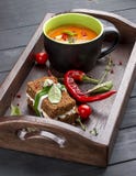 Cream-soup from tomatoes and baked pepper, with a multi-grain bread with smoked suluguni stock photography Cream-soup from tomatoes and baked pepper, with a multi-grain bread with smoked suluguni stock photography