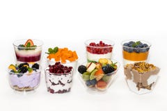 Creamy cream dessert in a plastic cup decorated with berries royalty free stock photos Creamy cream dessert in a plastic cup decorated with berries royalty free stock photos